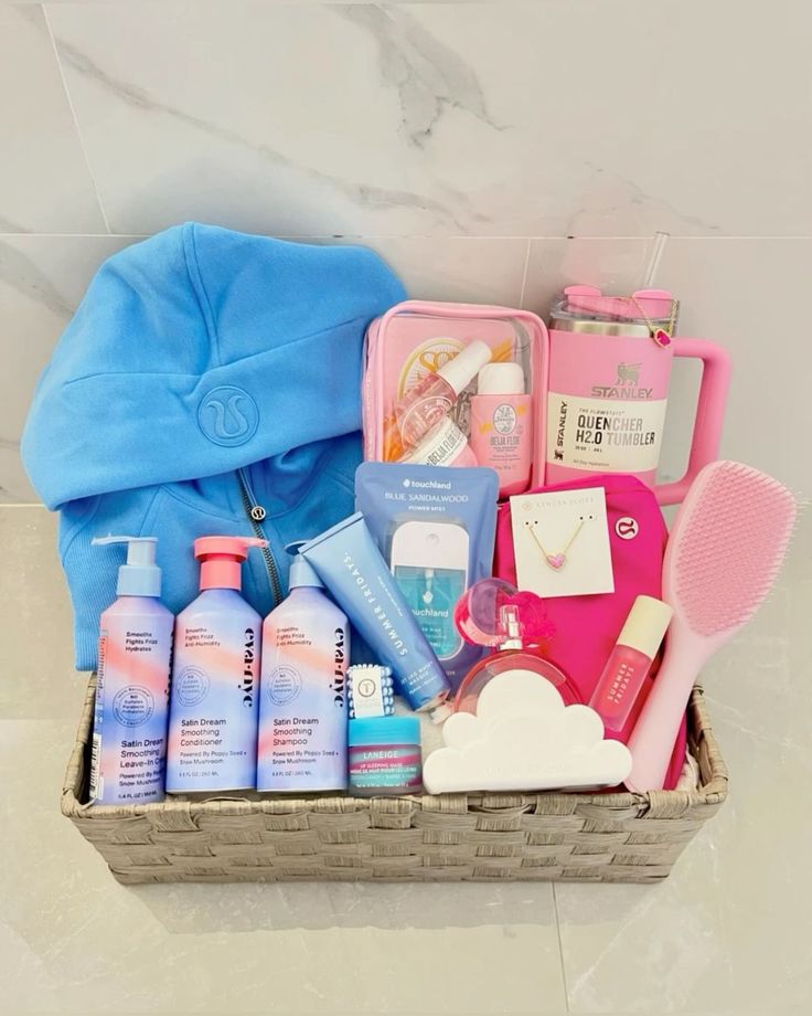 a basket filled with personal care items on top of a white tiled floor next to a blue bag