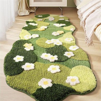 a green rug with white flowers on it