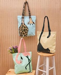 three purses are hanging on the wall next to a stool with flowers in it