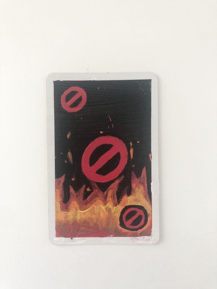 a square piece of paper with red and black designs on it that says no fire