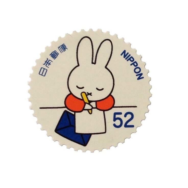 a white sticker with an image of a rabbit holding a carrot in it's mouth