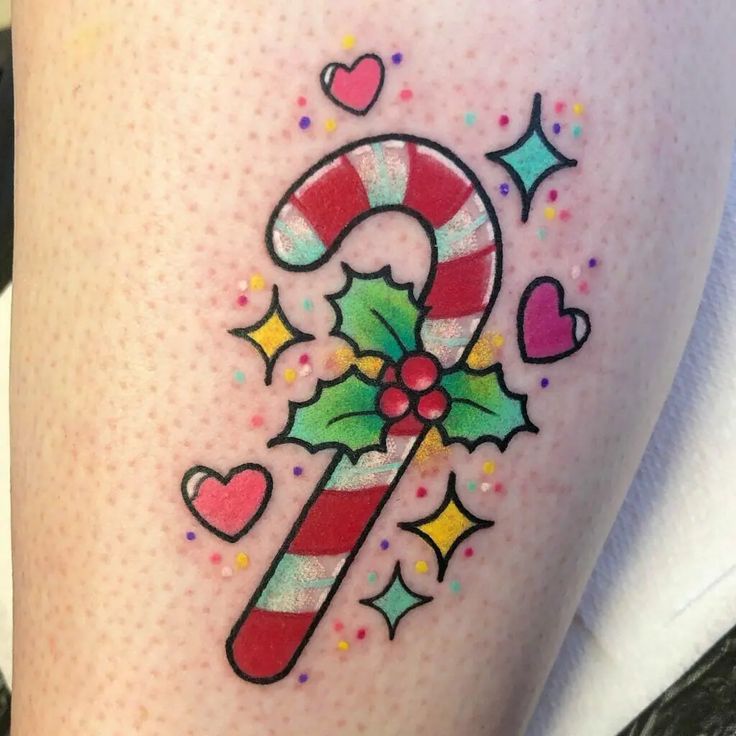 a candy cane tattoo on the thigh