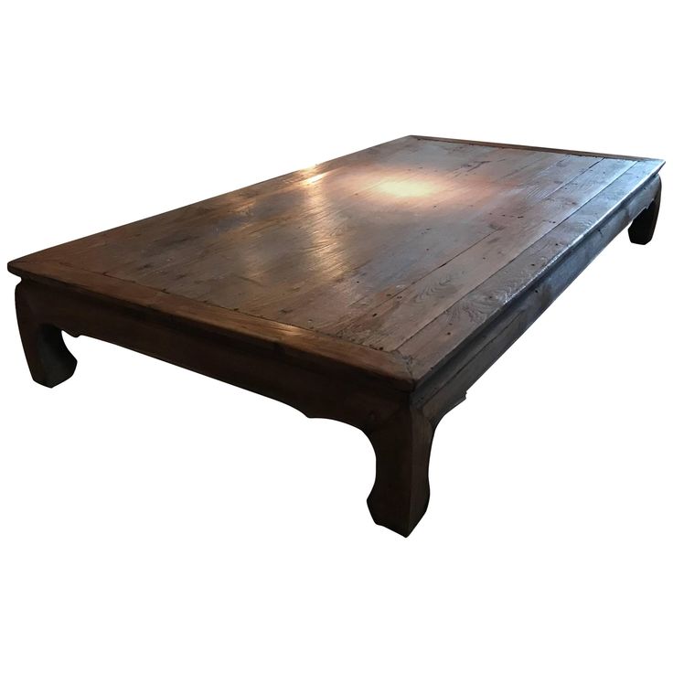 a large wooden table with two legs on it