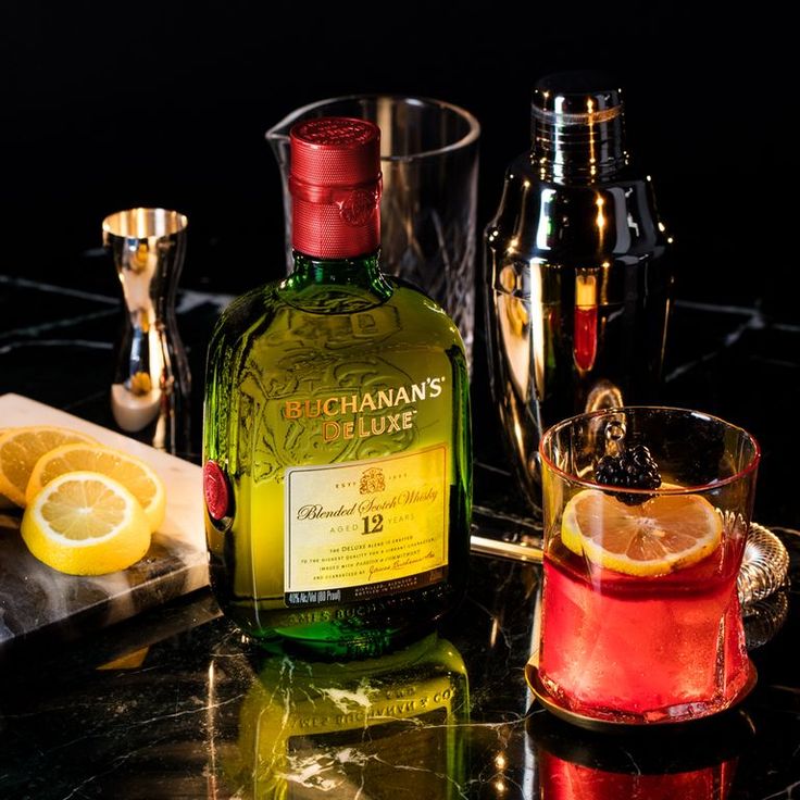 a bottle of boochahan's lime next to two glasses and a lemon slice