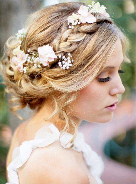 a woman with blonde hair and flowers in her hair