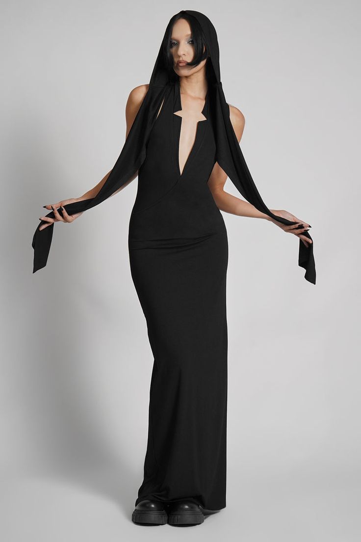 Make them take a second glance. Maxi dress made from luxuriously dense Jersey, featuring an add-on hood that can be draped across the shoulders and over the crown of the head, with plunging halter top neckline. FIT NOTES:Tatianna wears a size Small, 5'9, with a 26" waist.MATERIALS:95% rayon 5% spandexMade in China