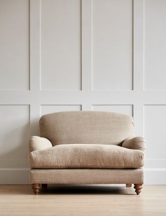 a chair sitting in front of a wall with white paneling and wood flooring