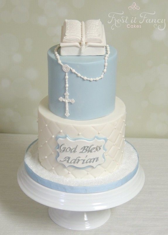 a blue and white cake with an open book on top