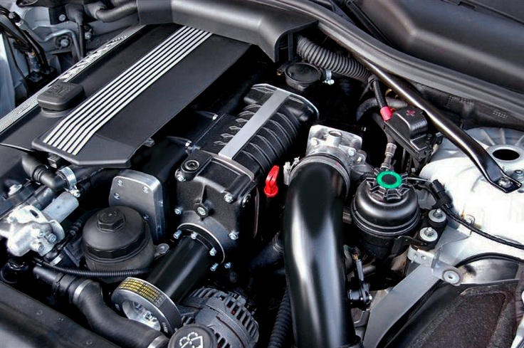 the engine compartment of a car with its hood up and it's air intake exposed