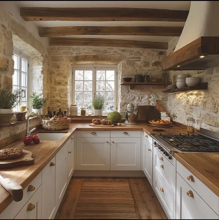 a kitchen with white cabinets and wooden counter tops, along with an oven in the center