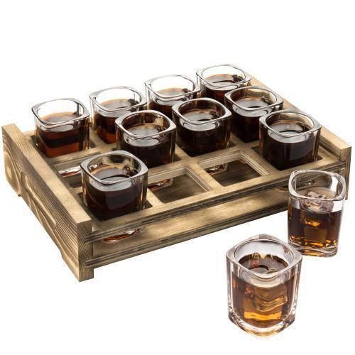 a wooden tray filled with lots of glasses next to two shot glasses on top of each other