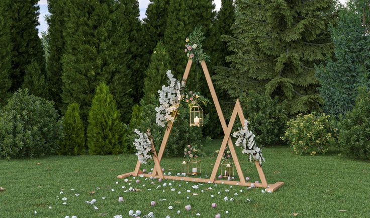 a wooden triangle with flowers on it in the grass