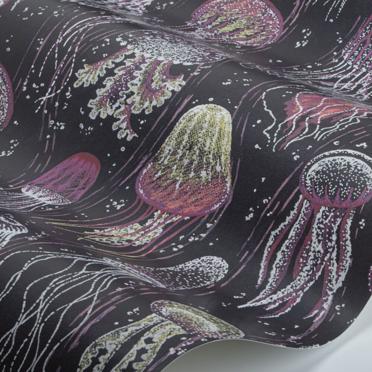 a close up of a tie with jellyfishs on it's black background