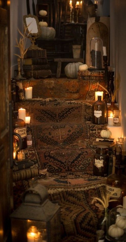 a room with candles and rugs on the floor