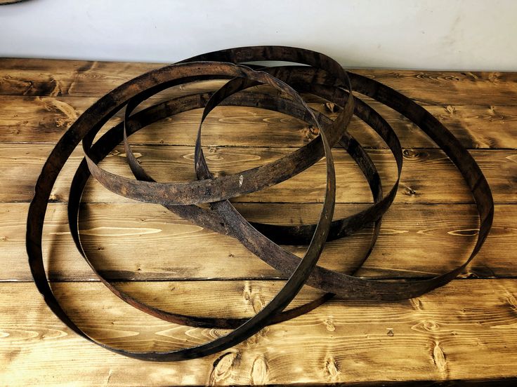 a bunch of metal rings sitting on top of a wooden table