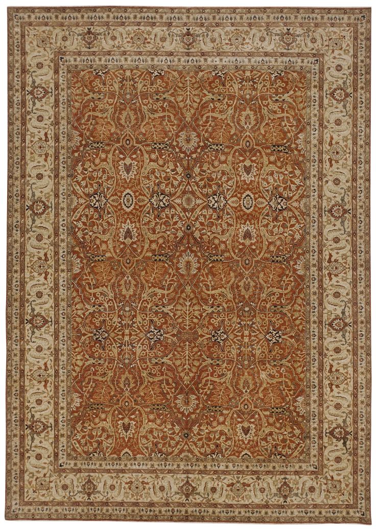 an orange and beige rug with floral designs