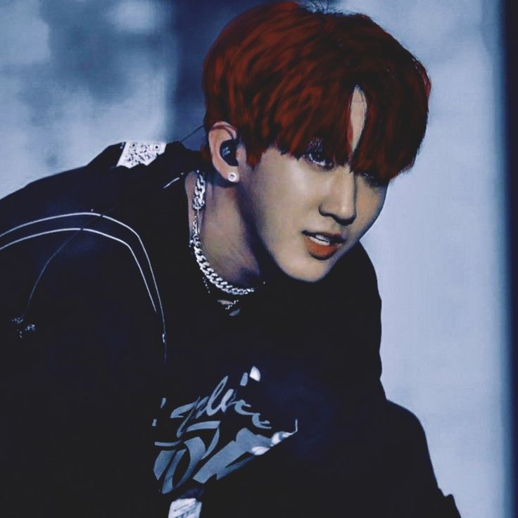 a young man with red hair and piercings