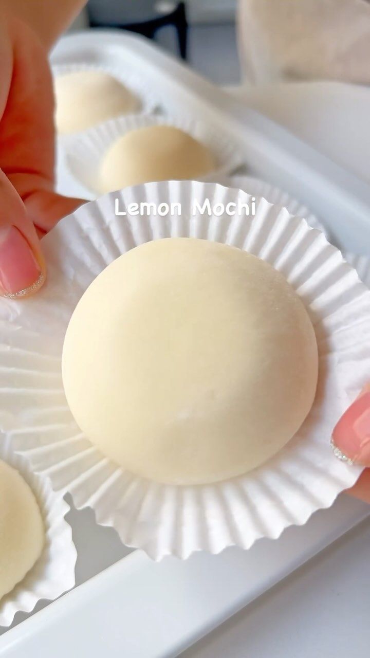 a person is placing some food on top of paper plates with their fingers and thumbnails