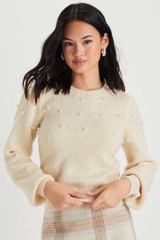 The Lulus Undeniable Glow Ivory Pearl Pullover Sweater will be your favorite way to make yourself shine this holiday season! This stunning sweater has a slightly fuzzy medium-gauge knit construction, with gleaming faux pearl details throughout, that shapes a classic crew neckline, long balloon-style sleeves with fitted cuffs, and a relaxed bodice. Contrasting ribbed knit accents the neckline, cuffs, and hem. Fit: This garment fits true to size. Length: Size medium measures 17.75" from shoulder t Beige Winter Party Sweater, Cream Winter Party Top, Cream Party Tops For Winter, Winter Cream Crew Neck Knit Top, Cream Crew Neck Knit Top For Winter, Elegant Cream Knit Top For Winter, Pearl Sweater Outfit, Fancy Sweater, Pearl Sweater