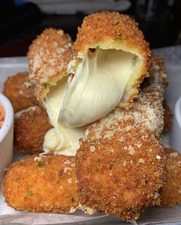 some food that is on a plate with dipping sauce in the middle and another bowl next to it