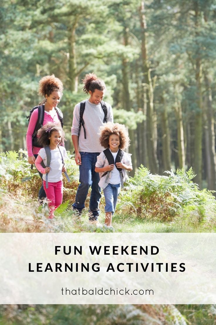 three adults and two children are walking through the woods with backpacks on their backs