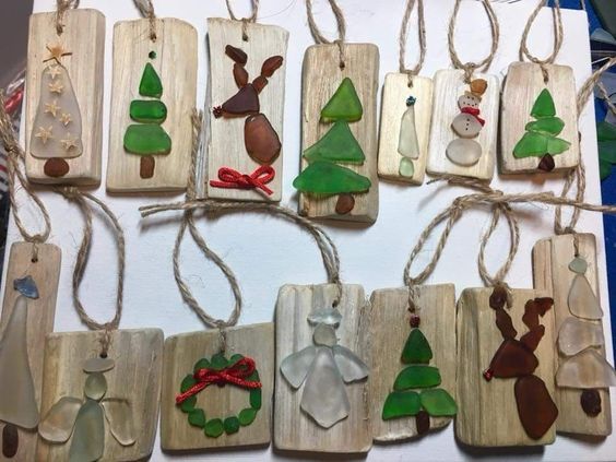 christmas ornaments are hanging on wooden boards with string attached to the strings, and decorated with glass ornaments