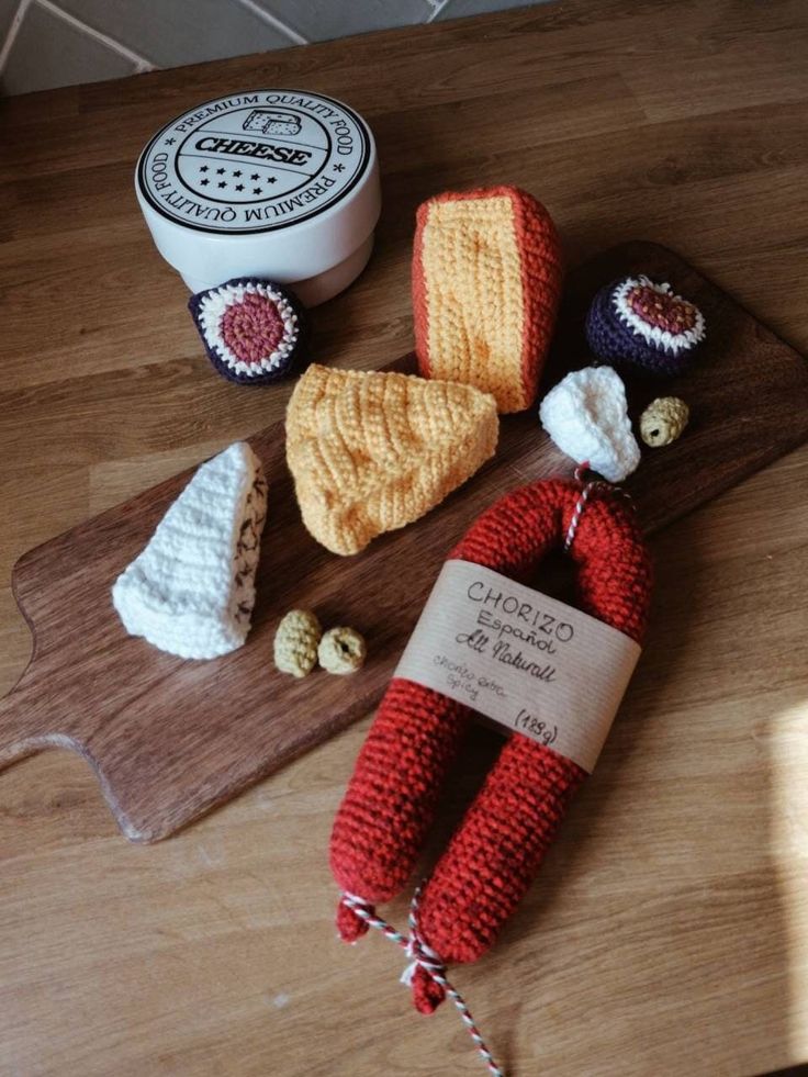 some crocheted items are on a wooden board