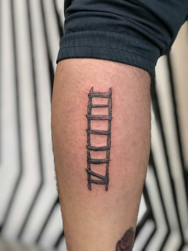 a person with a tattoo on their leg that has a ladder drawn on the side