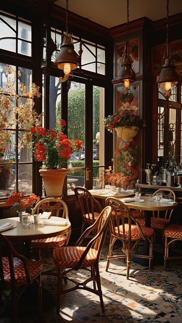 the sun shines through two large windows into a dining room with tables and chairs