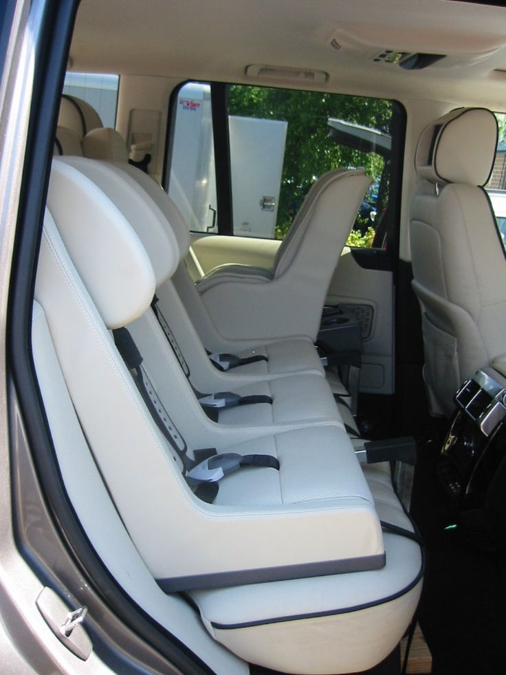 the interior of a vehicle with white leather seats