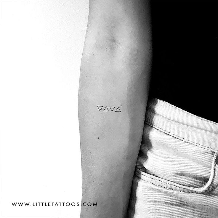 a woman's arm with a small tattoo on the left side of her arm