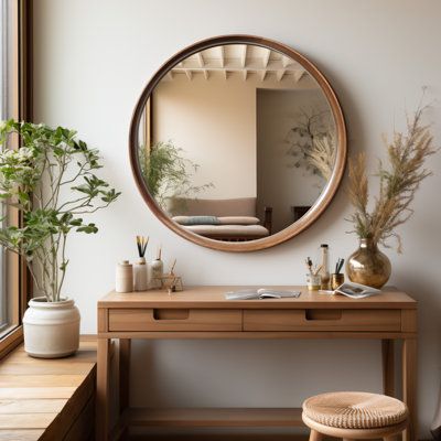 a wooden desk with a mirror on it next to a window and potted plants