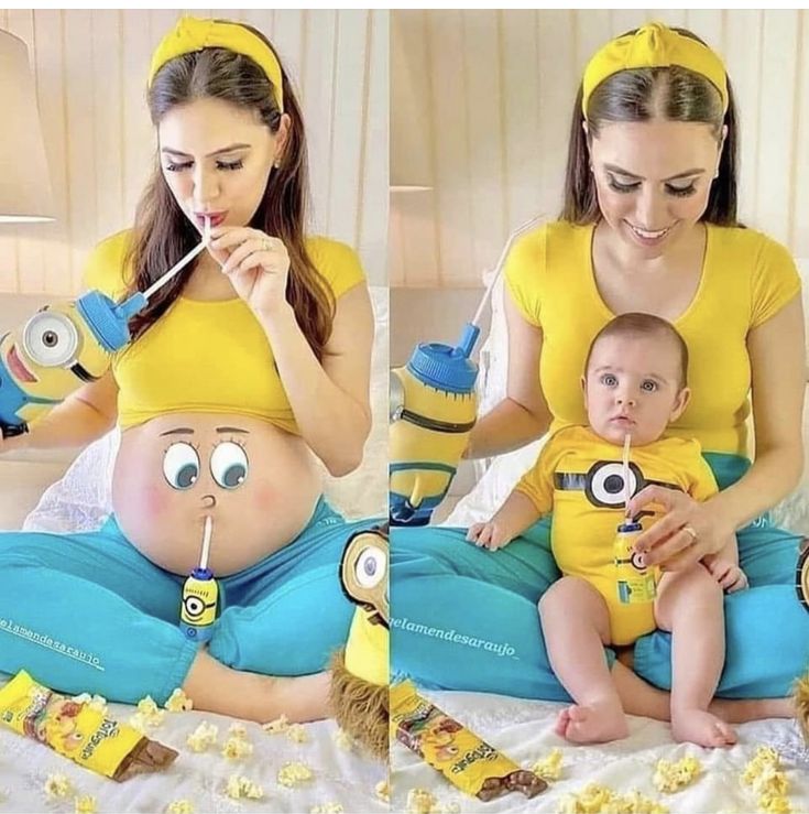 a woman is holding a baby in her lap and eating popcorn while sitting on the bed