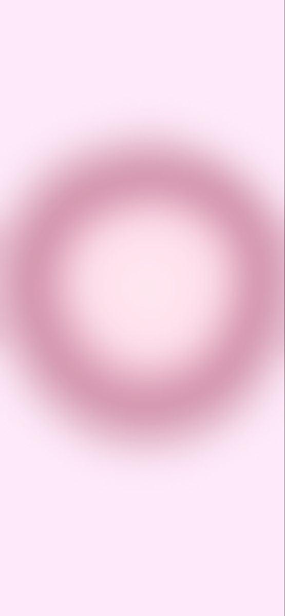 a blurry image of a circular object on a pink background