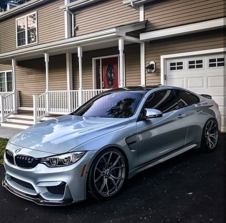 a silver car parked in front of a house