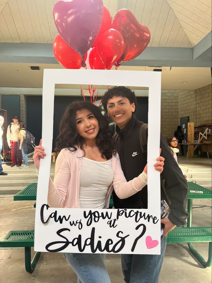 two people holding up a sign that says can you prepare for valentine's day?