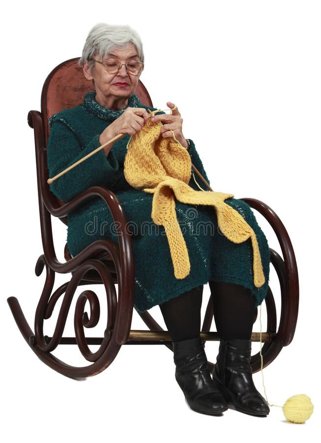 an elderly woman knitting on a rocking chair with a yellow yarn ball in her hand