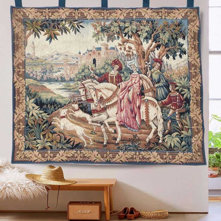 a tapestry hanging on the wall with a horse and rider in it's center