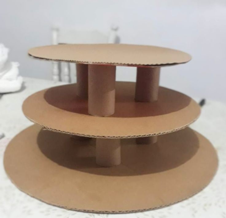 three cardboard plates stacked on top of each other in the shape of an upside down cake stand