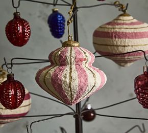 several ornaments are hanging from a metal tree