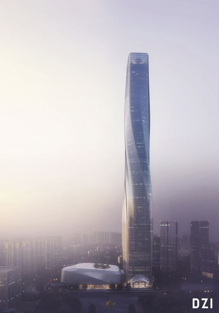 an aerial view of a tall skyscraper in the foggy city with buildings around it