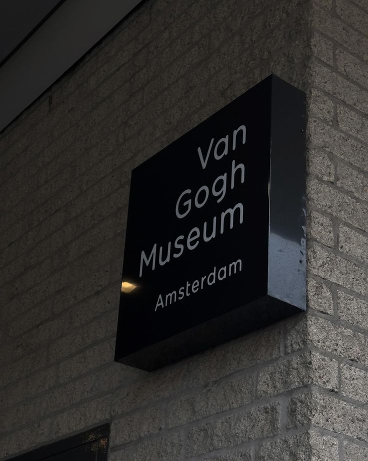 a sign on the side of a building that says van gogh museum, amsterdam