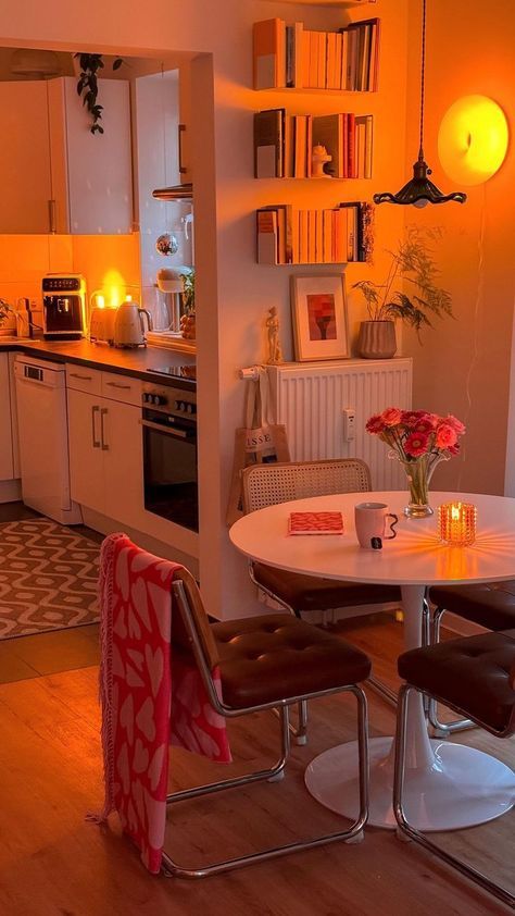 a kitchen with a table and chairs next to a stove top oven in the corner