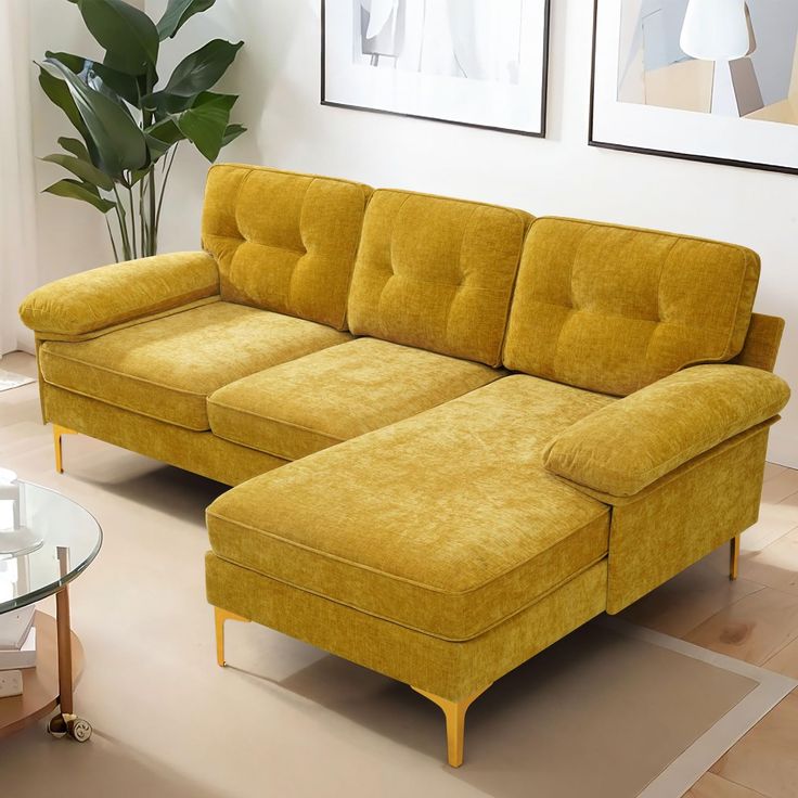 a living room with a yellow couch and coffee table