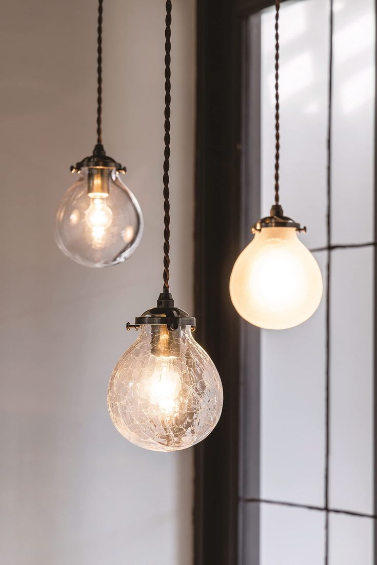 three light bulbs hanging from the ceiling