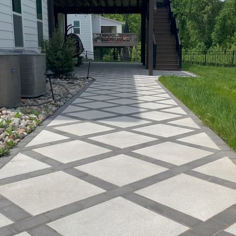 an outdoor walkway is shown in front of a house