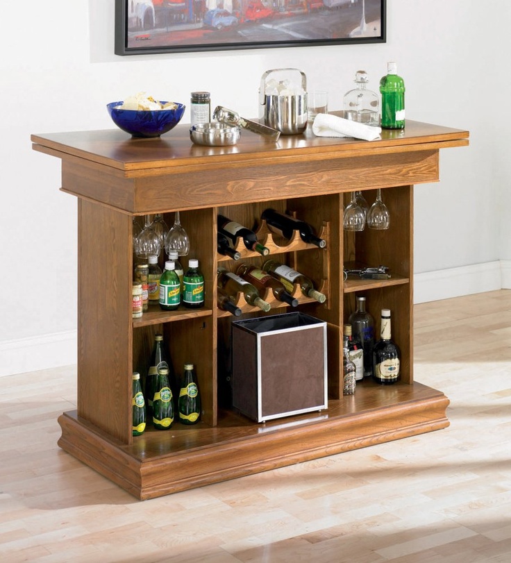 an entertainment center with wine glasses and liquor bottles