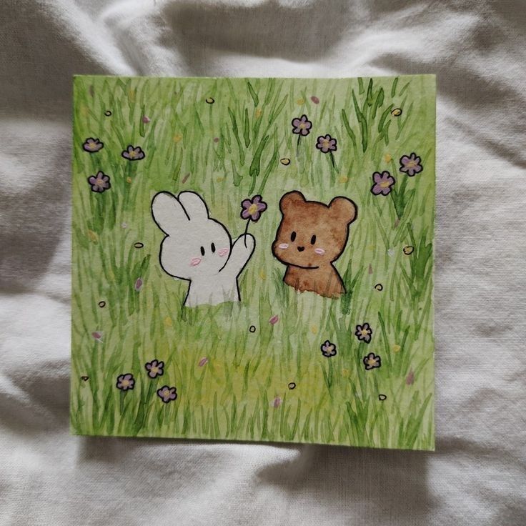 a drawing of two bears in the grass with flowers and butterflies around them on a sheet of paper