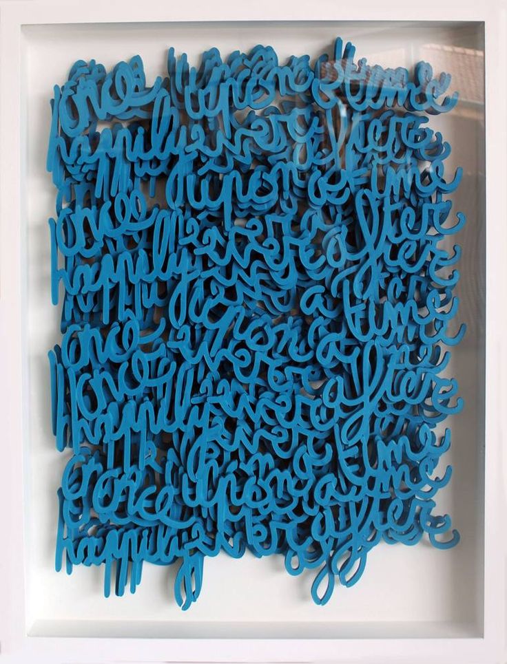 a blue sculpture is in a white frame on the wall and it looks like letters