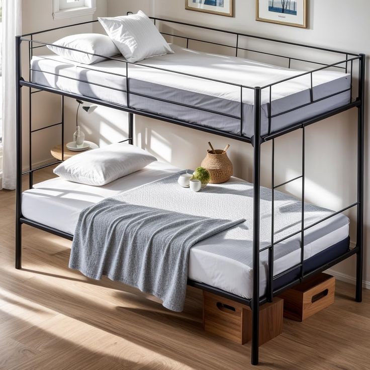 a metal bunk bed with two mattresses on the bottom, and one under it